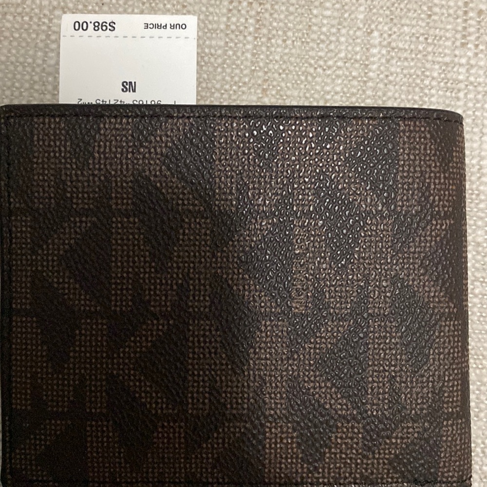 Michael Kors wallet going for $98 very good condition. Brand new